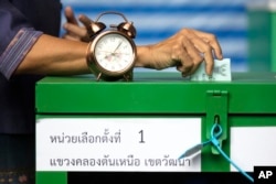 A woman casts her vote at a polling station in Bangkok, Thailand, March 24, 2019, during Thailand's first general election since the military seized power in a 2014 coup.