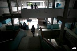 Students walk inside their public high school in Caracas, Venezuela, June 1, 2016. While the school locks its gate each morning, armed robbers still manage to infiltrate and stick up kids between classes.