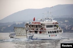 A Turkish-flagged passenger boat carrying migrants to be returned to Turkey leaves the port of Mytilene on the Greek island of Lesbos, April 8, 2016.