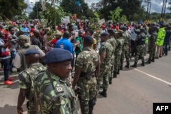 FILE - Malawian demonstrators march through the streets to protest against alleged poor governance by President Peter Mutharika's government in Lilongwe, April 27, 2018.