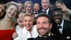 This image released by Ellen DeGeneres shows actors front row from left, Jared Leto, Jennifer Lawrence, Meryl Streep, Ellen DeGeneres, Bradley Cooper, Peter Nyong’o Jr., and, second row, from left, Channing Tatum, Julia Roberts, Kevin Spacey, Brad Pitt, L