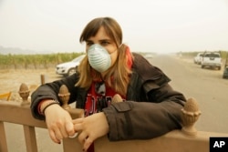 Angela Pardo works at the main entrance gate to the Gundlach Bundschu winery, Oct. 10, 2017, in Sonoma, California.