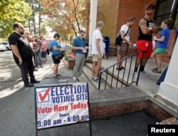 People arrive to cast their ballots in the 2016 elections at a polling station as early voting begins in North Carolina, in Carrboro, North Carolina, Oct. 20, 2016.