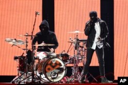 Josh Dun, left, and Tyler Joseph of the music group Twenty One Pilots performs at the 2016 iHeartRadio Music Festival - Day 1 held at T-Mobile Arena in Las Vegas.