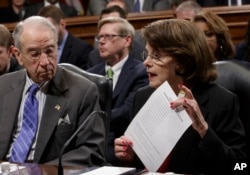 Senate Judiciary Committee Chairman Sen. Charles Grassley, R-Iowa, listens as the committee's ranking member Sen. Dianne Feinstein, D-Calif., requests a one-week postponement for the panel to vote on Supreme Court nominee Neil Gorsuch, as she displays a list of appointments made during presidential election years on Capitol Hill in Washington, March 27, 2017.