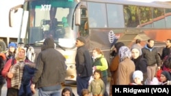 New arrivals are transferred by bus to other refugee camps in Athens, Greece, March 17, 2016.