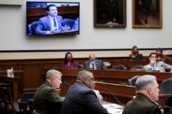 Gen. Kenneth McKenzie, commander of the U.S. Central Command, Defense Secretary Lloyd Austin and Joint Chiefs Chairman Gen. Mark Milley testify as Congressman Matt Gaetz appears on a screen during a House Armed Services Committee hearing on Capitol Hill in Washington, Sept. 29, 2021.