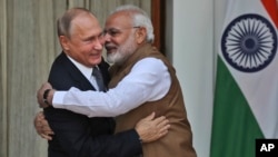 FILE - Indian Prime Minister Narendra Modi, right, hugs Russian President Vladimir Putin before their meeting in New Delhi, India, Oct. 5, 2018.