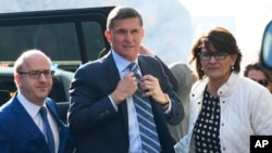 FILE - Former Trump national security adviser Michael Flynn, center, arrives at federal court in Washington, Dec. 1, 2017.