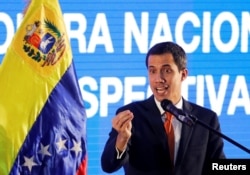 Venezuelan opposition leader Juan Guaido, who many nations have recognized as the country's rightful interim ruler, speaks during a meeting with representatives of the oil sector in Caracas, Venezuela, Feb. 5, 2019.