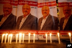 Candles, lit by activists, protesting the killing of Saudi journalist Jamal Khashoggi, are placed outside Saudi Arabia's consulate, in Istanbul, during a candlelight vigil, Oct. 25, 2018.