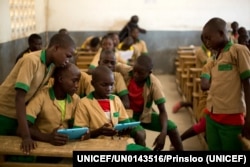 FILE - Students learn with the help of computer tablets provided by UNICEF at a school in Baigai, northern Cameroon. The aid group initiated the 'Connect My School' pilot project in January 2017. (Courtesy of UNICEF)