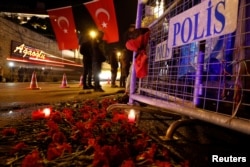 Flowers are placed in front of a police barrier near the entrance of Reina nightclub by the Bosphorus, which was attacked by a gunman, in Istanbul, Turkey, Jan. 1, 2017.