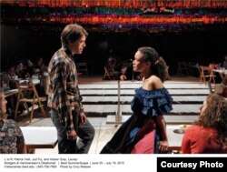 Patrick Vaill as Jud Fry and Amber Gray as Laurey perform in Gideon Lester's production of "Oklahoma!," which placing the audience close to the action — at long tables on all four sides of the staging area.