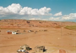 FILE - This Navajo home stands isolated in a small canyon east of Tuba City, Ariz. Radio is often the only way to get news and information out to tribal members in rural reservations.