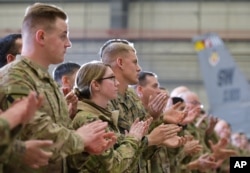 Troops applaud as U.S. Vice President Mike Pence speaks in a hangar at Bagram Air Base in Afghanistan, Dec. 21, 2017.