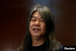 FILE - Pro-democracy lawmaker Leung Kwok-hung speaks to journalists at the Legislative Council in Hong Kong, Nov. 30, 2016.