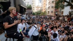 FILE - Cantonese pop singer and outspoken activist Denise Ho, left, performs during a free concert at a street in Hong Kong, June 19, 2016.