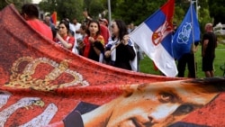 Members of the local Serbian community hold flags and banners outside a government detention center where Serbia's tennis champion Novak Djokovic is staying in Melbourne, Australia, on Jan. 8, 2022.