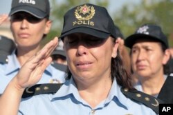 A colleague cries as friends carry the coffin of a police officer killed during a failed military coup last Friday, during his funeral at Kocatepe Mosque in Ankara, Turkey, July 17, 2016.