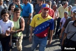 Venezuelan presidential candidate Henri Falcon walks during a campaign event at the slum of Catia in Caracas, April 2, 2018.