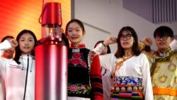 Students and volunteers take an oath of service as they stand near the Olympic flame during an event at the Beijing University of Posts and Communications in Beijing, Dec. 9, 2021. It was one of the first public events to display the flame since its arrival from Greece in October.