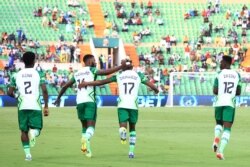 Nigeria's forward Samuel Chukwueze (C) celebrates with teammates after scoring the opening goal during the Group D Africa Cup of Nations (CAN) 2021 football match between Nigeria and Sudan at Stade Roumde Adjia in Garoua, Jan. 15, 2022.