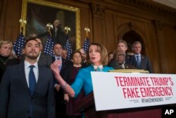 House Speaker Nancy Pelosi of California, accompanied by Rep. Joaquin Castro, D-Texas, left, and others, speaks about a resolution to block President Donald Trump's emergency border security declaration on Capitol Hill, Feb. 25, 2019, in Washington. Congress eventually voted to block the emergency declaration, but that led to Trump's first veto.