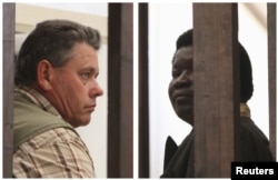 A combination photo shows Zimbabwean safari operator Honest Ndlovu, right, and fellow countryman and hunter Theo Bronkhorst waiting to appear in Hwange magistrates court, July 29, 2015.