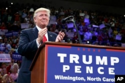 Republican presidential candidate Donald Trump applauds during a campaign rally at the University of North Carolina Wilmington, Tuesday, Aug. 9, 2016.