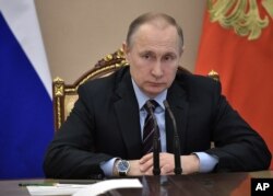 FILE - Russian President Vladimir Putin heads a Cabinet meeting in Moscow, April 12, 2017.
