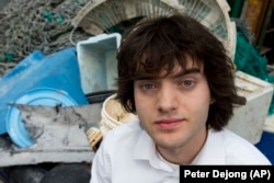 Dutch inventor Boyan Slat stands next to a pile of plastic garbage prior to a 2017 press conference in Utrecht, Netherlands.