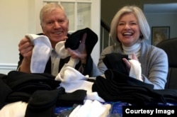 Tom Costello, Jr. founder and chief sock person with wife Nancy Costello with what else...a pile of new socks