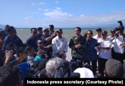 Indonesian President Joko "Jokowi" Widodo arrives in Palu, Central Sulawesi, to see the damage done by an earthquake and tsunami at Talise Beach as well as the downtown of Palu, Sept. 30, 2018.