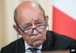 FILE - France's Foreign Minister Jean-Yves Le Drian listens during a news conference after his talks with Russian counterpart Sergey Lavrov, in Moscow, Sept. 8, 2017.