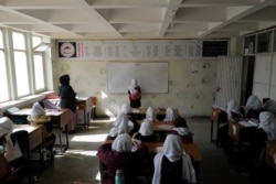 Hadia, 10, a 4th grade primary school student attends a class in Kabul, Afghanistan, Oct. 26, 2021. The hardline Islamist Taliban movement has allowed all boys and younger girls back to class, but has not let girls attend secondary school.