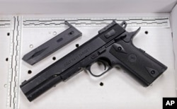 FILE - The fake handgun taken from 12-year-old Tamir Rice is displayed in November 2014 after a news conference in Cleveland.