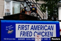 Federal Bureau of Investigation personnel search an address during an investigation into Ahmad Khan Rahami, who was wanted for questioning in an explosion in New York, which authorities believe is linked to the explosive devices found in New Jersey, Sept. 19, 2016.