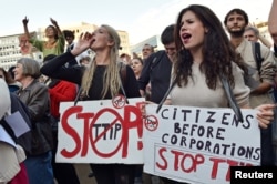 FILE - Thousands of people demonstrate against the Transatlantic Trade and Investment Partnership (TTIP) and the EU-Canada Comprehensive Economic and Trade Agreement (CETA) in the center of Brussels, Belgium, Sept. 20, 2016.