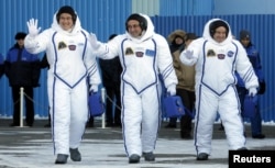 Members of the International Space Station expedition 54/55, Roscosmos cosmonaut Anton Shkaplerov, center, NASA astronaut Scott Tingle, right, and Norishige Kanai, left of the Japan Aerospace Exploration Agency during the send-off ceremony at the Baikonur