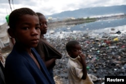 Children stand next to a flooded area after Hurricane Matthew passes Cite-Soleil in Port-au-Prince, Haiti, Oct. 5, 2016.