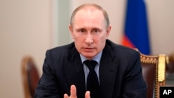 Russian President Vladimir Putin speaks at a Security Council meeting at the Kremlin in Moscow, Russia, March 28, 2014.