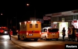German emergency services workers work in the area where a man with an ax attacked passengers on a train near the city of Wuerzburg, Germany, early July 19, 2016.