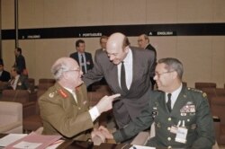 FILE - United Kingdom Chief of Staff Field Marshall Sir Richard Vincent, left, with NATO Secretary General Manfred Woerner and U.S. Chief of Staff Gen. Colin Powell, right, at the NATO Defense Minister meeting in Belgium, Dec. 12, 1991.