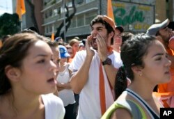 FILE - University students protest against President Nicolas Maduro in Caracas, Venezuela, Thursday, Nov. 3, 2016. The students are demanding that Maduro respect the constitution and allow an electoral solution to the country's political crisis.
