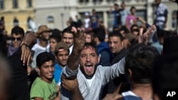 A man shouts during a protest at the Keleti train station in Budapest, Sept. 4, 2015.