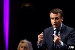 French presidential candidate for the "En Marche" movement Emmanuel Macron delivers a speech during a campaign meeting, Feb. 28, 2017, in Angers, western France.