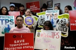 FILE - People gather during a news conference at the New York Immigration Coalition following U.S. President Donald Trump's announcement to end the Temporary Protection Status program for Salvadoran immigrants in Manhattan, New York City, Jan. 8, 2018.