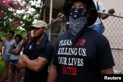 A demonstrator stands during protests in Baton Rouge, Louisiana, U.S., July 10, 2016.