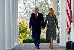 President Donald Trump and first lady Melania Trump walk out of the Oval Office and towards the Rose Garden of the White House, Tuesday, Nov. 24, 2020, in Washington, to pardon Corn, the national Thanksgiving turkey. (AP Photo/Susan Walsh)